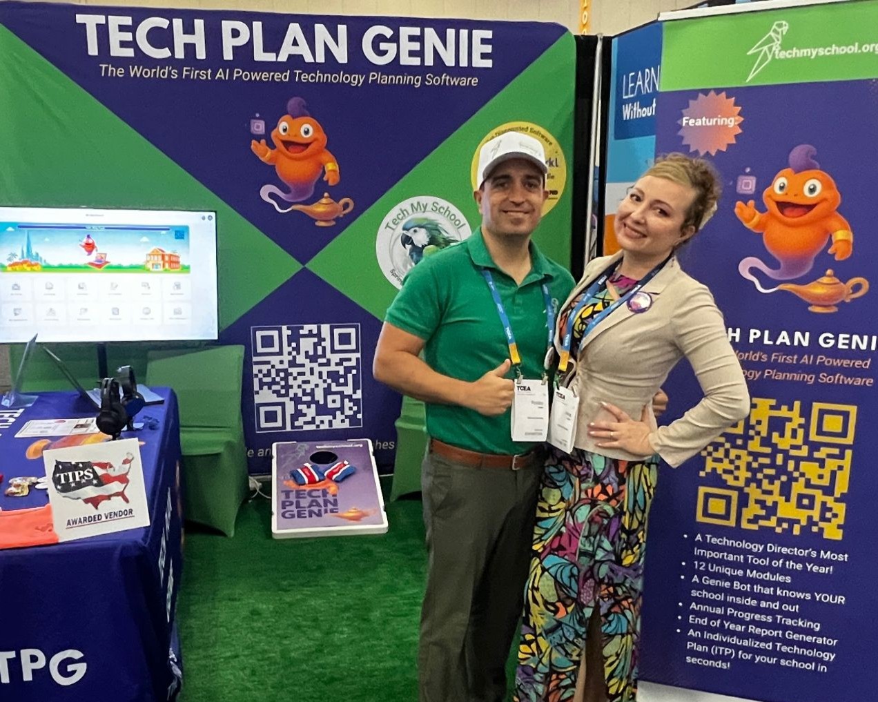 Robert and Irina Cobbs at the Tech My School conference booth, in front of the Tech Plan Genie banner